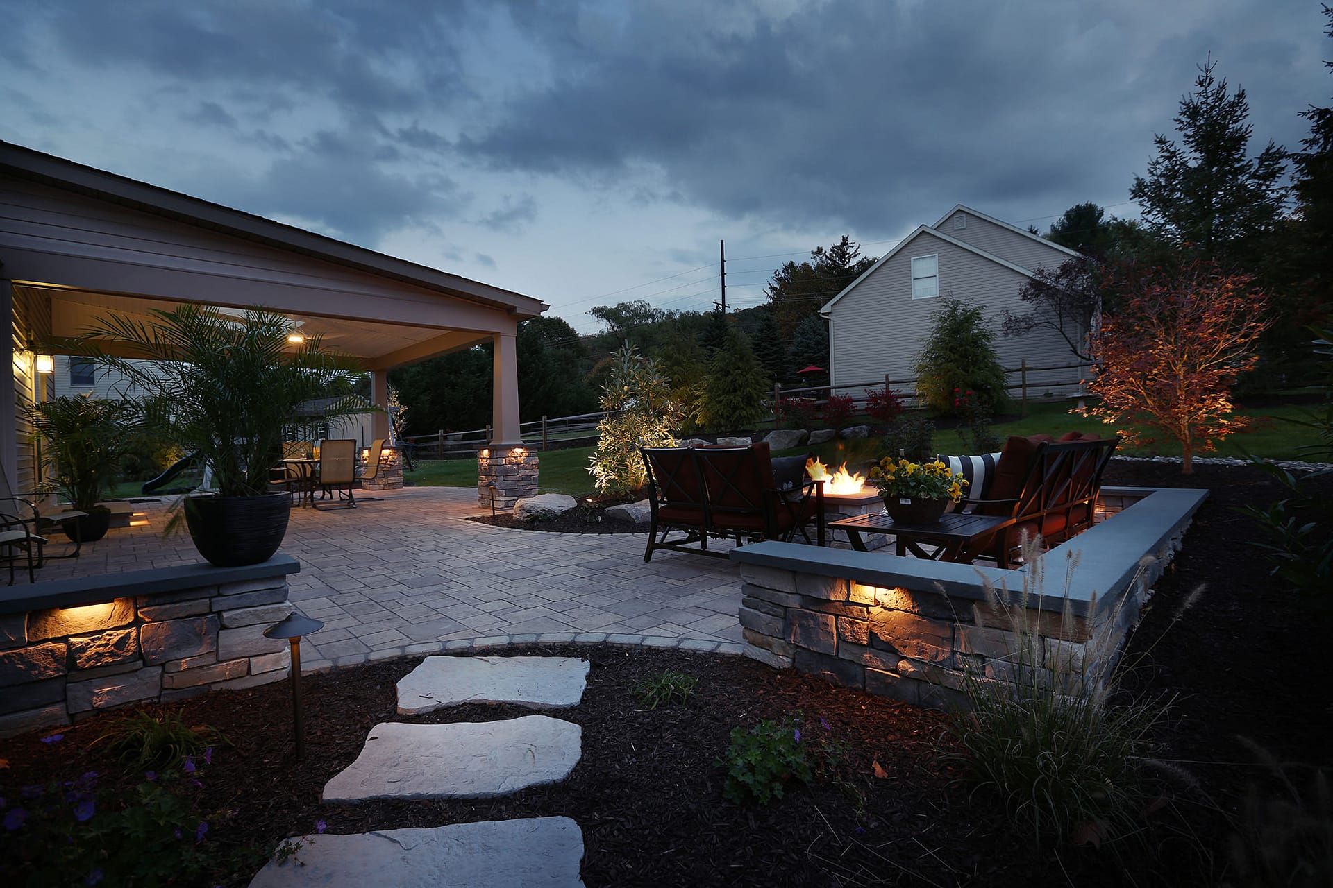 This stone wall doubles as wrap around seating for the fire pit.