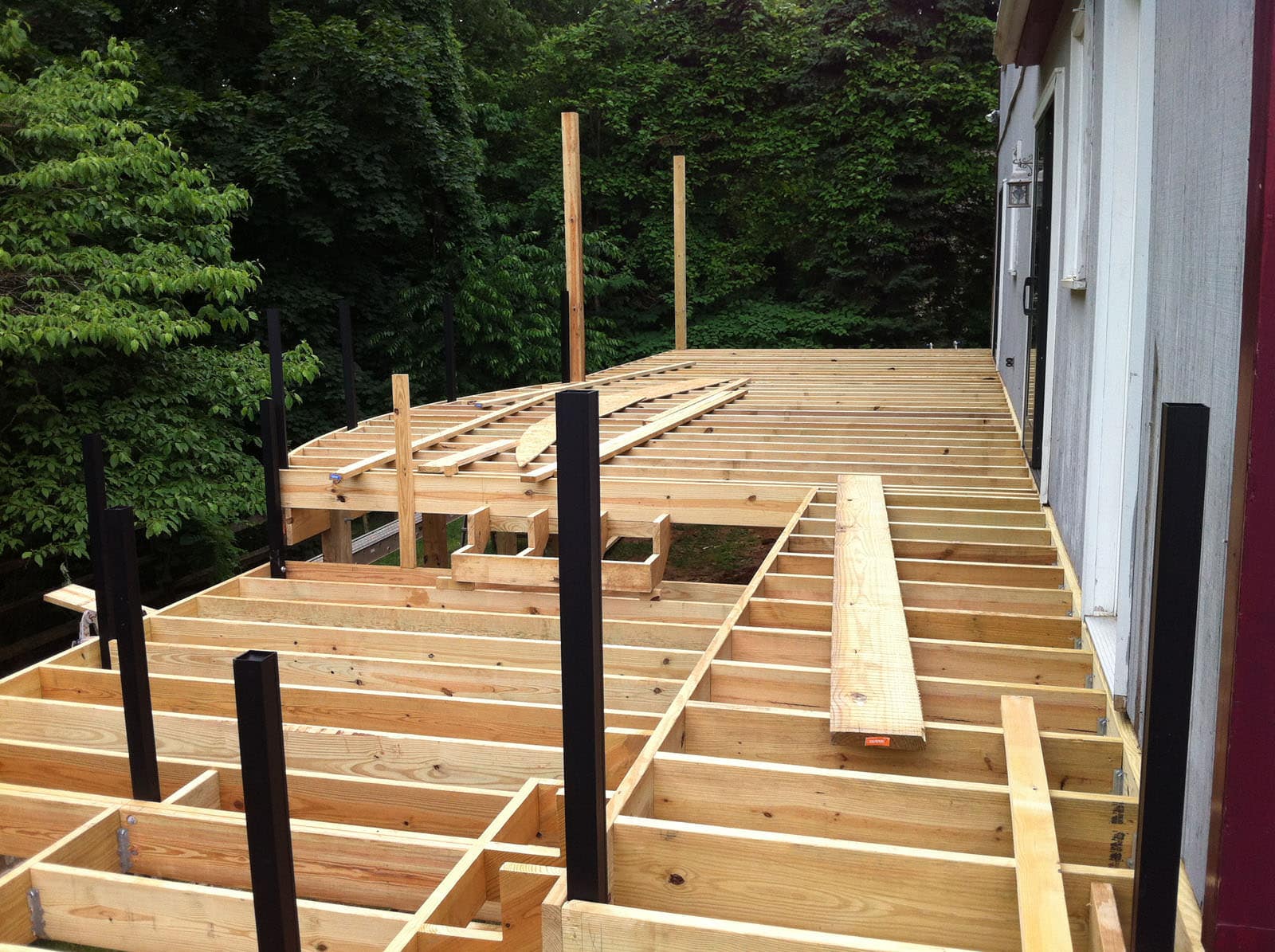 With the old pressure treated deck removed, the new deck framing started right away!