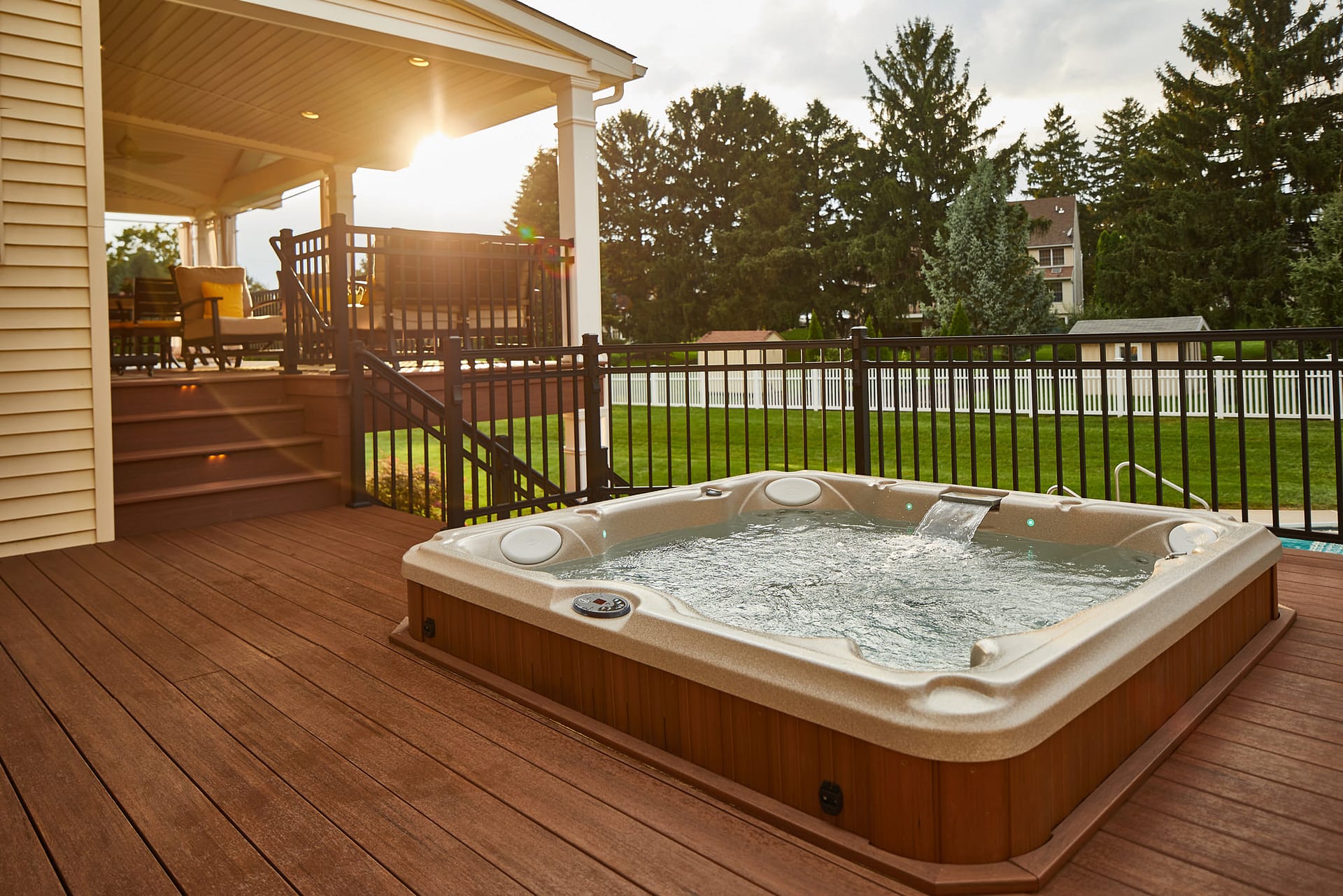 Sinking the hot tub in the deck eliminates the bulk of the feature and keeps the design clean and open!