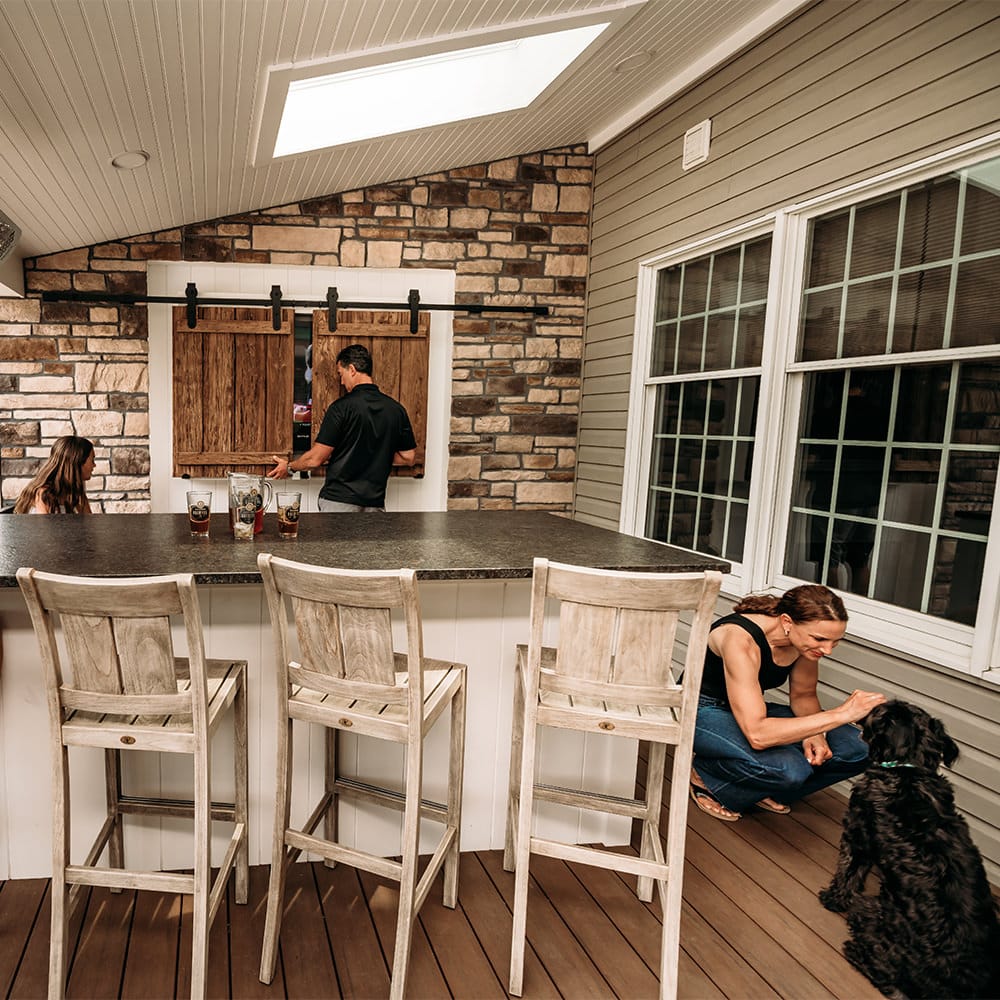 This custom entertainment space gives the family options to open or close the barnwood doors to reveal or hide their outdoor tv. Beauty + function=MasterPLAN Outdoor Living!
