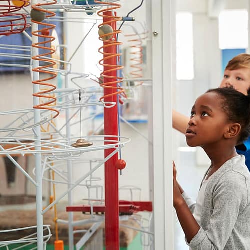 children engaging with museum exhibit