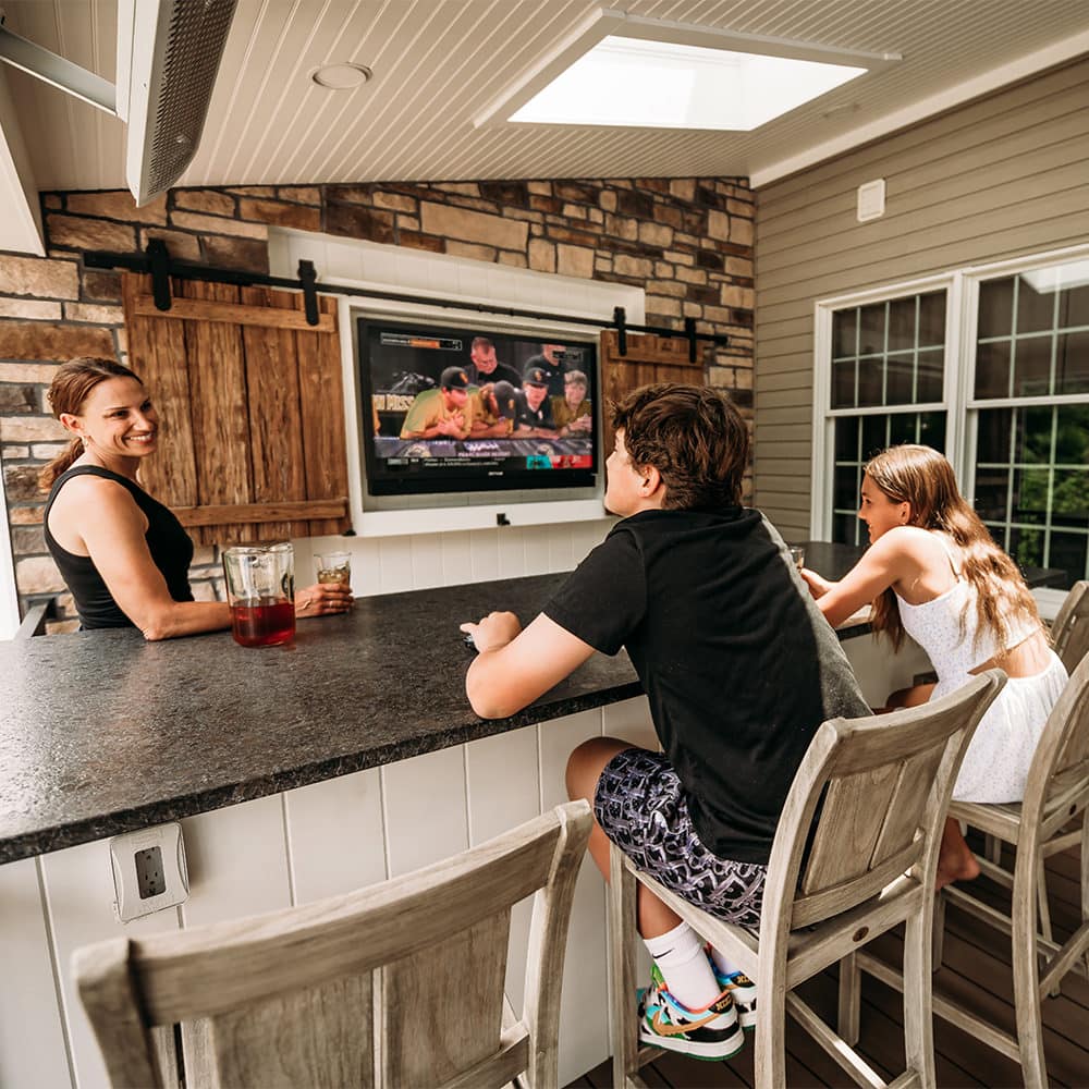 This fun outdoor living space in Bethlehem, PA draws the family outside every day to catch up with each other and connect on that day’s game!