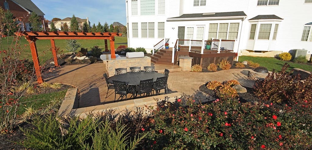 Stamped concrete patio with wood pergola and outdoor dining area in a Lehigh Valley backyard