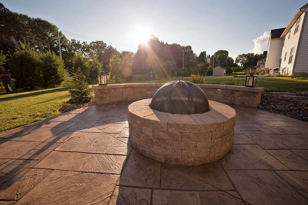 A fire pit and seating wall on a patio