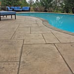 Stamped concrete pool deck with coping