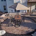 Area for a dining table sits on a stamped concrete patio