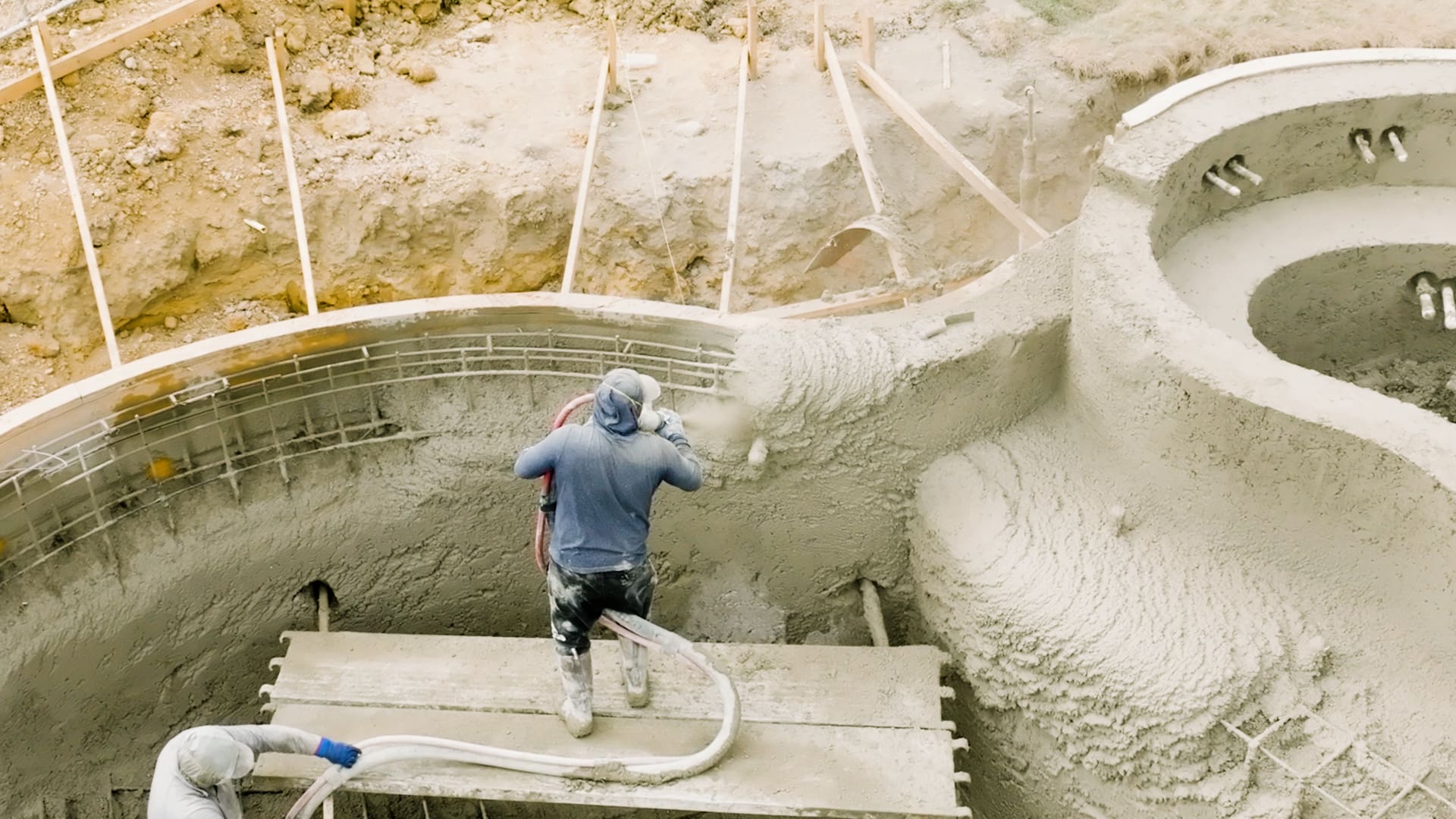 A nozzleman shoots shotcrete with accuracy.