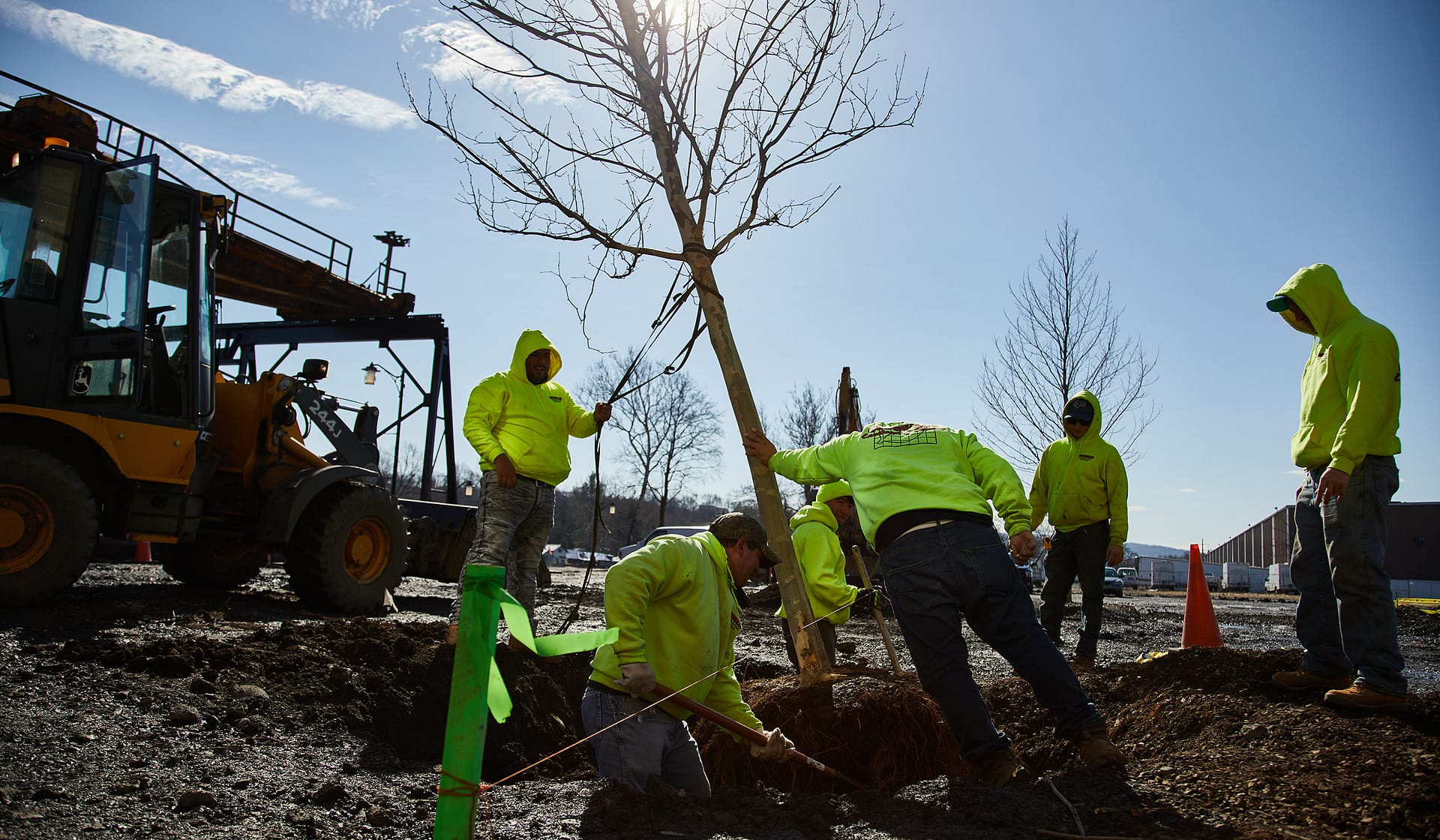 Landscaping crew planting greenery around 615 Waterfront at The Waterfront