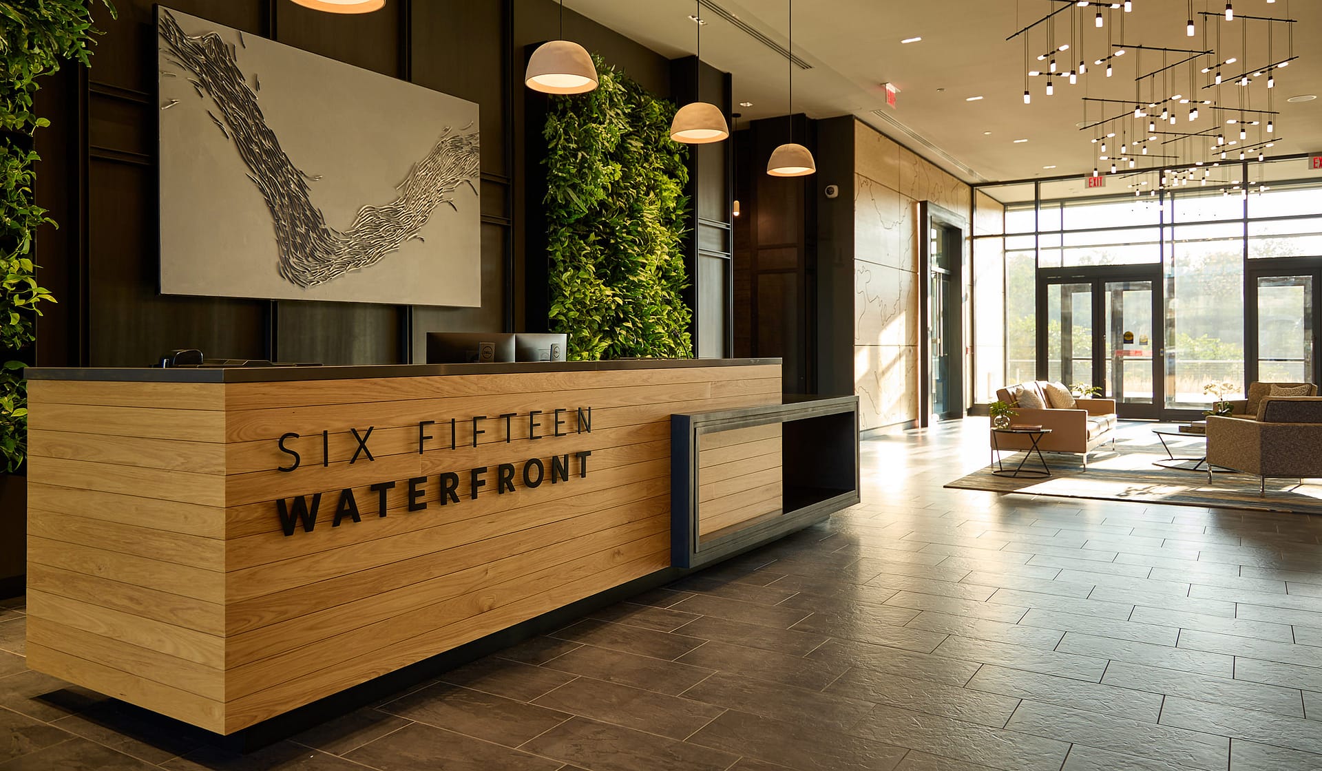615 Waterfront reception desk with living green wall and signage in the Allentown office lobby