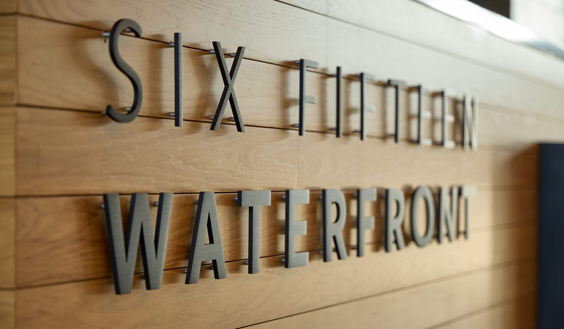 615 Waterfront signage lettering on a stone wall in the Allentown office lobby