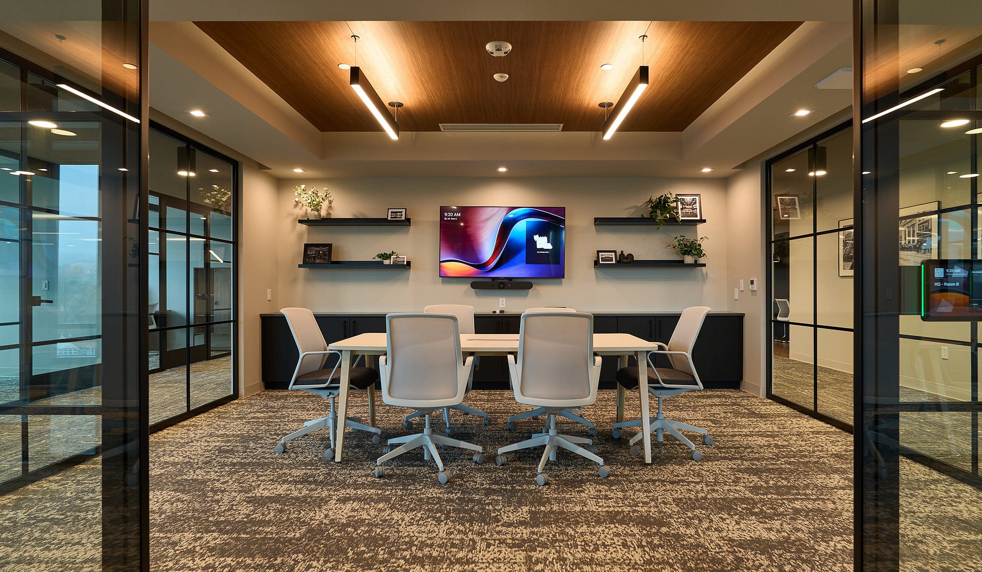 Glass-walled conference room with media display in a 615 Waterfront tenant suite