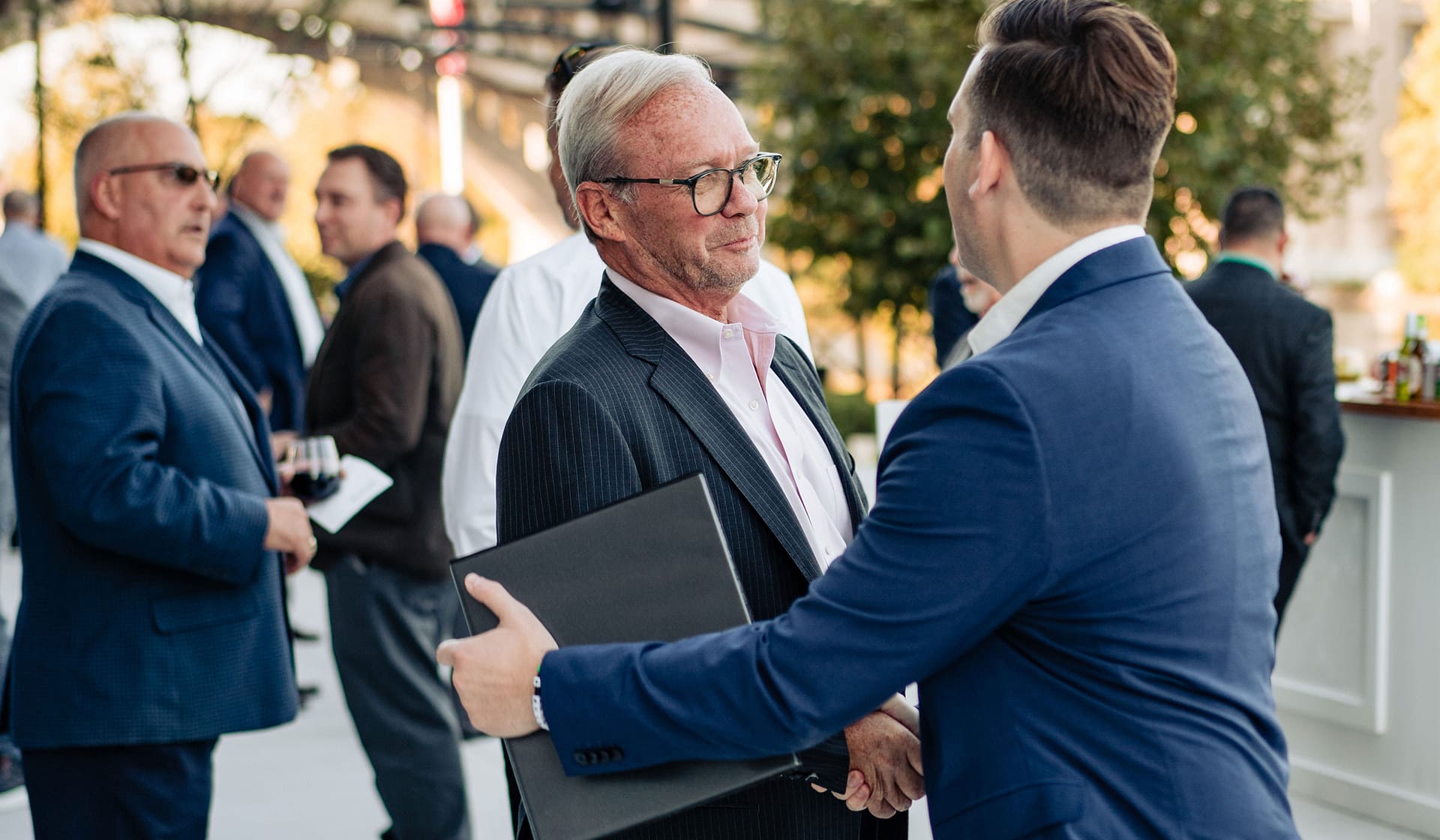 Guests in business attire mingling at the 615 Waterfront grand opening reception