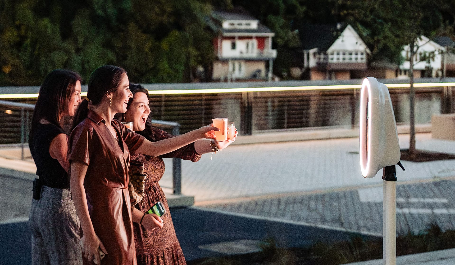Guests taking a selfie at dusk during the grand opening at The Waterfront