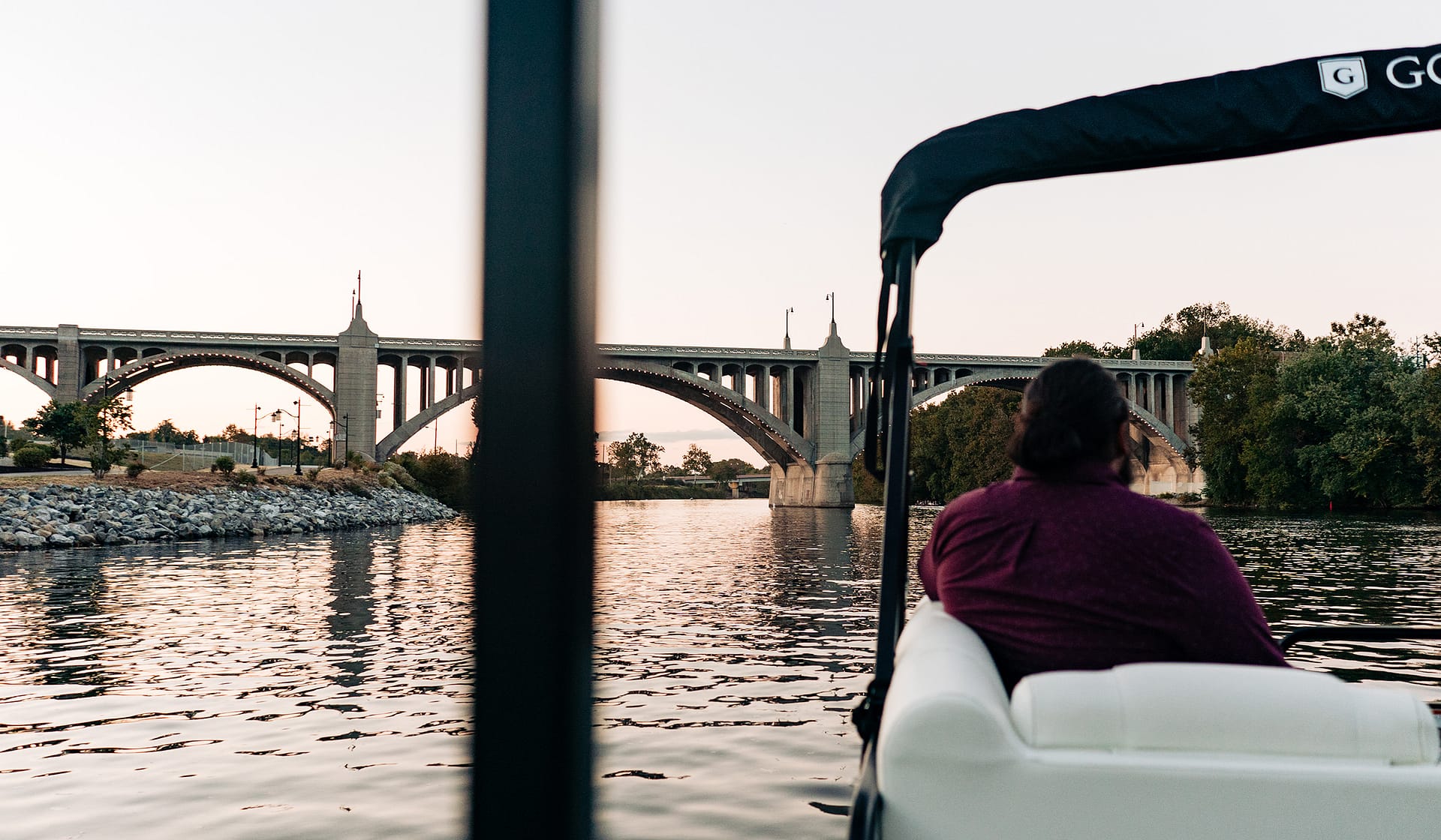 Arched bridge over the Lehigh River seen at dusk from a terrace at The Waterfront