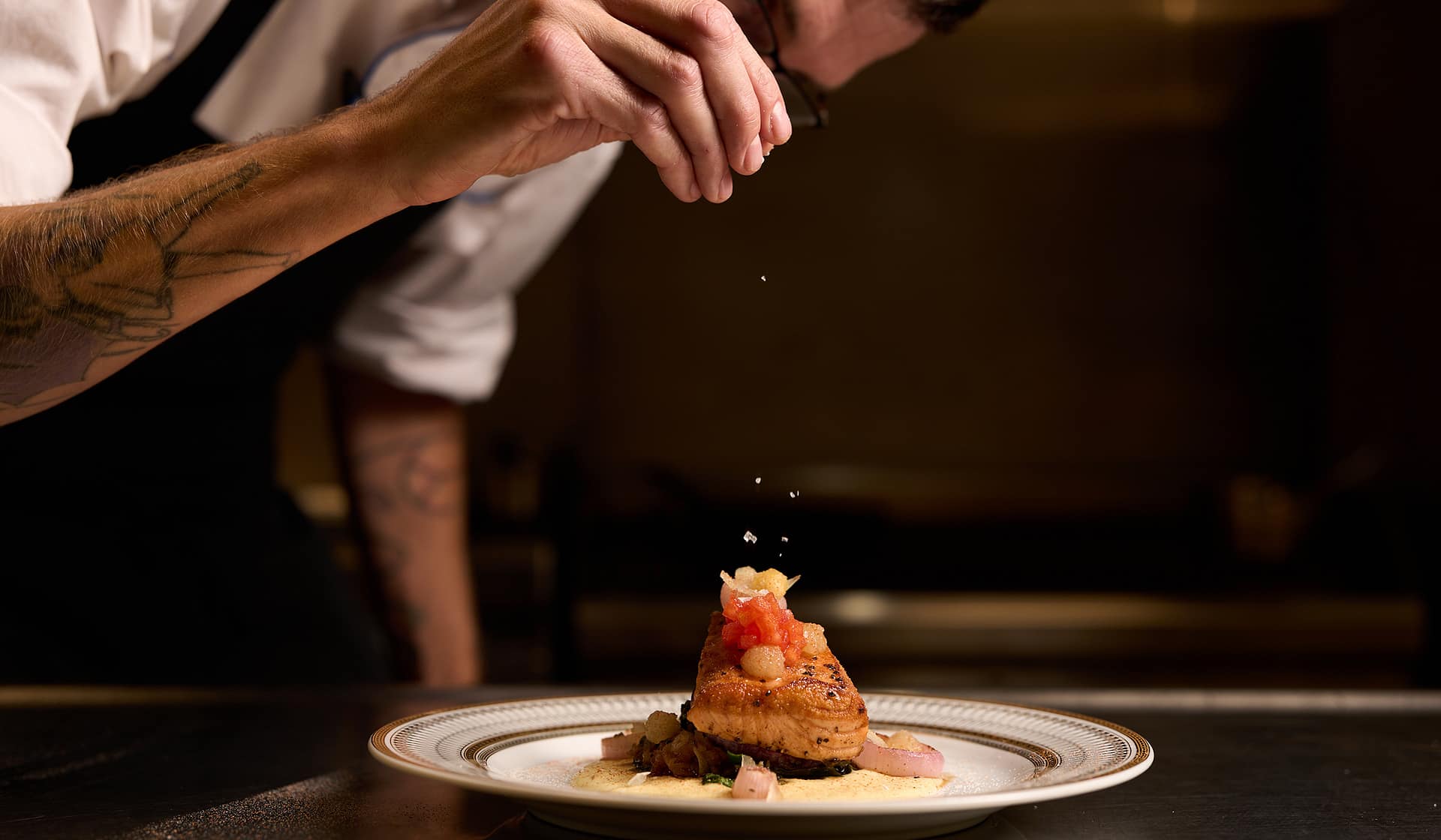 Chef Tyler garnishing an elegantly plated dish at Nowa in Allentown