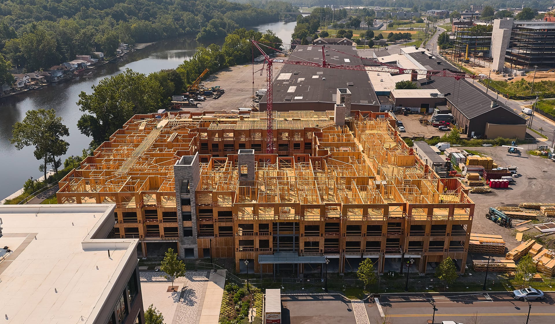 Sunset crane work over the framed structure of River House at The Waterfront