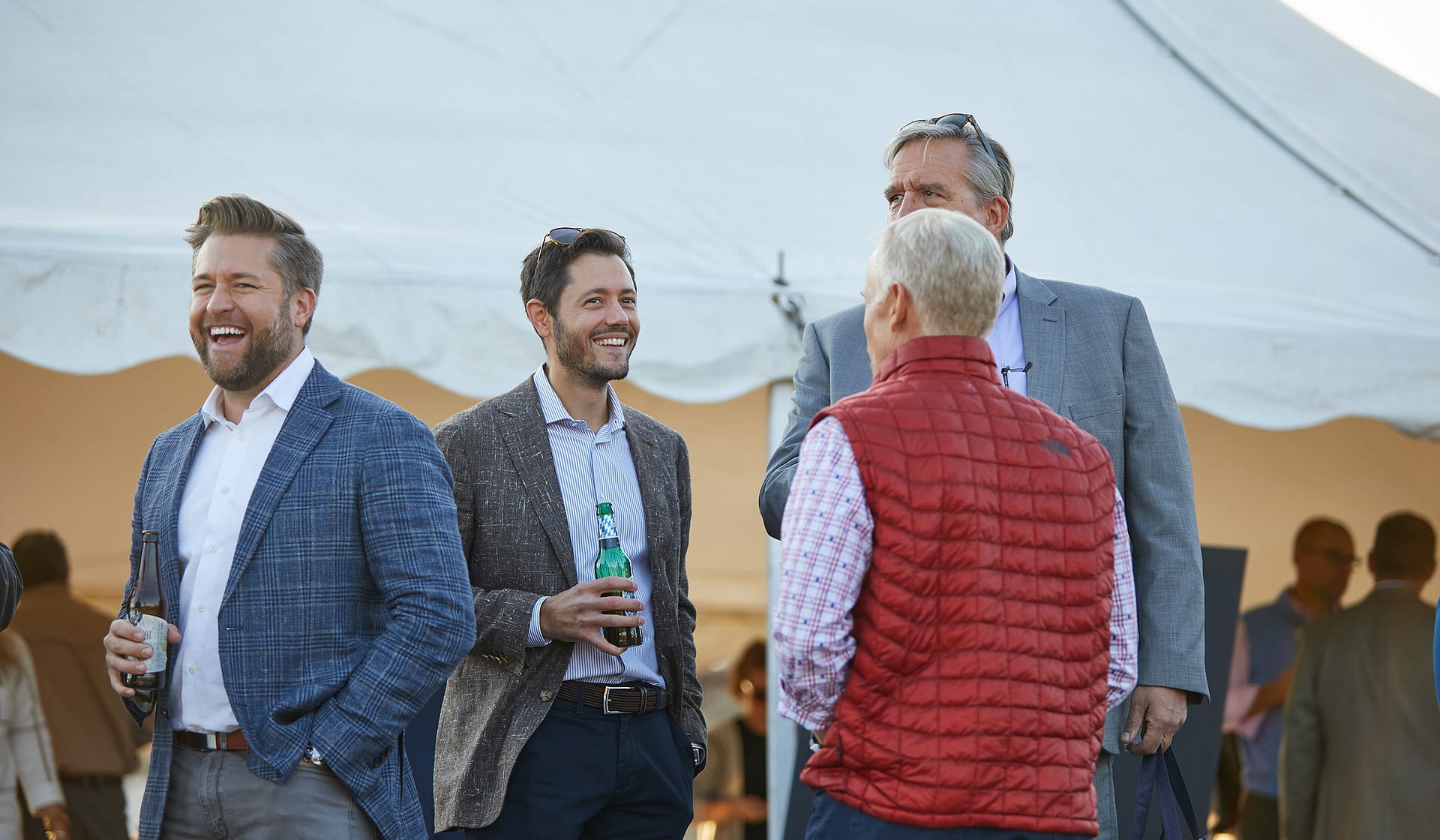 Three guests chatting outdoors at a broker event at The Waterfront in Allentown