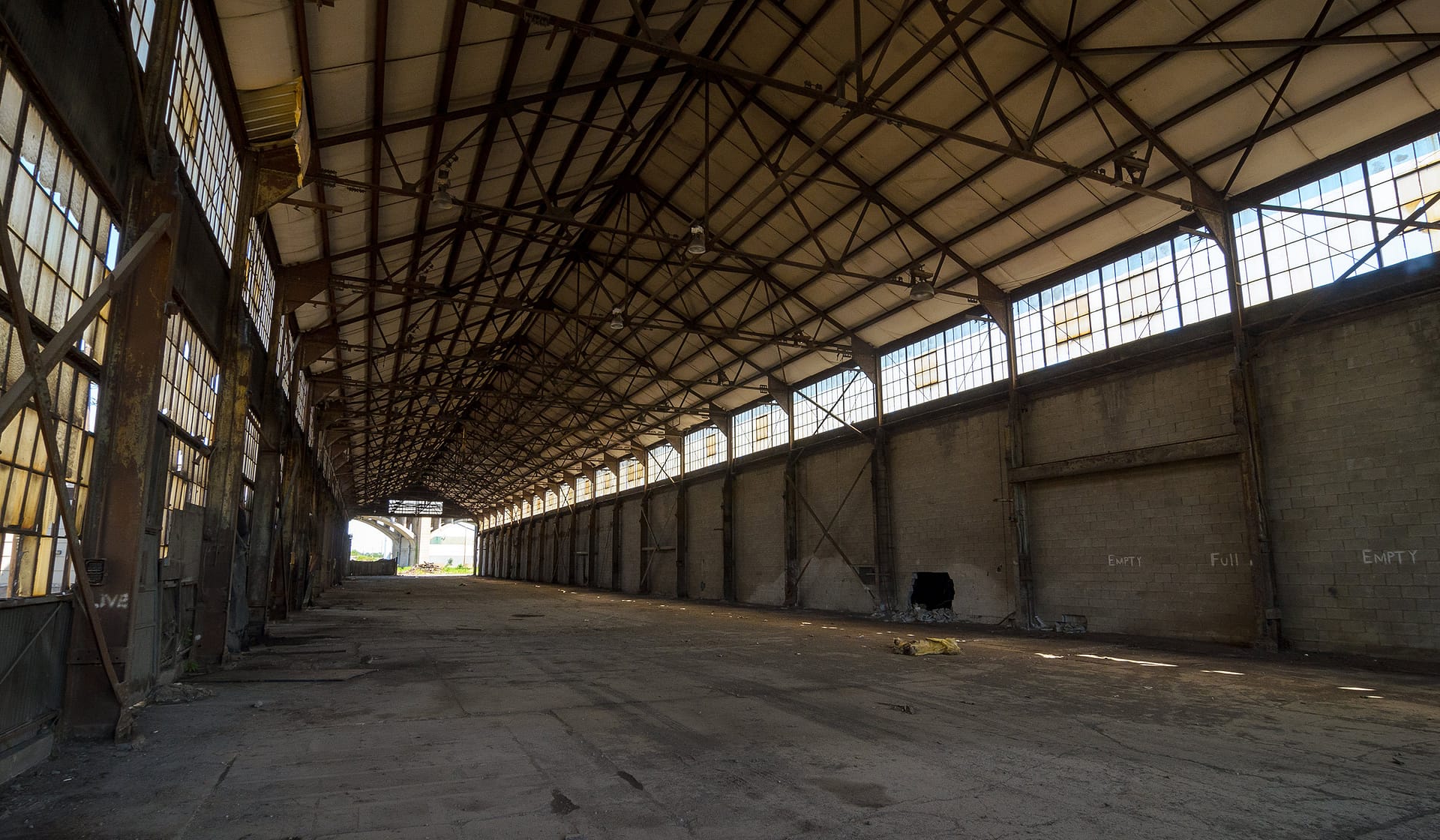 Empty interior of a vast historic industrial shed before redevelopment at The Waterfront